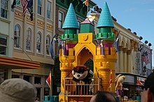 Taz and Honey Bunny from Looney Tunes ride a colourful castle-themed float during the daily parade.