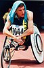 Australian T50 wheelchair athlete Fabian Blattman shades himself with a towel while he waits for his event at the 1996 Atlanta Paralympic Games.