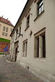 Facade from Kanonicza Street with Gothic windows of the first floor and a window above them