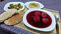A bowl of kubbeh adom, or red kubbeh in a beet broth