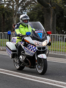 Motorcycle policeman at Law enforcement in Australia, by John O'Neill