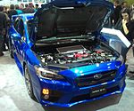 Open engine compartment of a Subaru WRX STI for the international (non-Japanese) market, showing the horizontally-opposed "boxer" engine coded "EJ257"