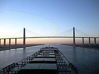 Post-deepening, a capesize bulk carrier approaches the Friendship Bridge