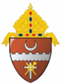 The arms of the Diocese of Brownsville: The tincture of the field, tenné, is depicted as brown, referencing the seat of the diocese, Brownsville, Texas.
