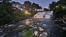 Glen Falls on Ellicott Creek in Williamsville NY, August 2021, with the moon overhead and a privately-owned spotlight illuminating the falls.