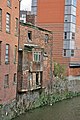 Image 49A 19th-century slum dwelling. The overhang contained privies, whose waste fell straight into the River Medlock below. (from History of Manchester)