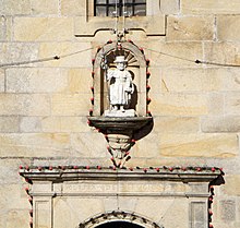 A niche with a white statue of Saint James. Under it, the top of a gate is visible. On it is engraved "YGLESIA DE REFVGIO"
