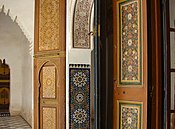 A variety of vernacular decorative Islamic styles in Morocco: wooden panels, zellij tilework, stucco calligraphy, and floral door panels
