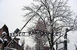 Porten till förintelselägret Auschwitz med texten Arbeit macht frei, översatt Arbete ger frihet.