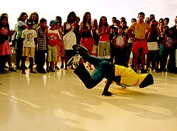 A b-boy performing in Turkey surrounded by a group of spectators