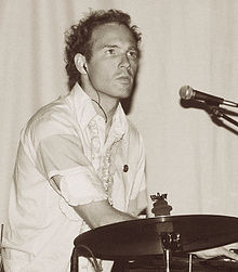 Snaith behind a cymbal and microphone