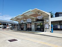 A bus platform with an angular concrete canopy