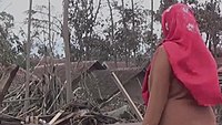 A villager staring at her house that was destroyed by the eruption.