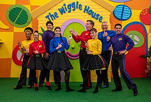 The Wiggles lineup in 2022 (L–R: Tsehay Hawkins, Caterina Mete, Lachlan Gillespie, Lucia Field, Simon Pryce, Evie Ferris, Anthony Field, John Pearce)