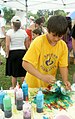 A child tie-dying a T-shirt