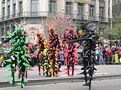 Brightly-coloured stilt walkers on the Place de la Bourse