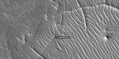 Close view of ridge networks, as seen by HiRISE under HiWish program. Arrow points to small, straight ridge.