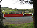 Fintown Railway on trackbed of CDR County Donegal Railways Joint Committee, next to Lough Finn with a train in the platform at Fintown station.