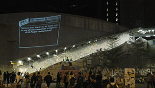 Lennon Wall with a projected message from "Add Oil Machine"