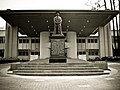 Statue of Lee Kong Chian, a major donor, after whom the Kong Chian Administration Centre in the background is named