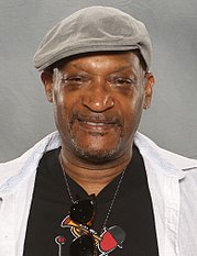 Tony Todd, an African-Americal male, is looking directly at the camera wearing a hat.