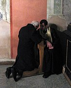 A penitent confessing his sins in a Catholic church in Lviv, Ukraine