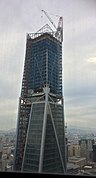 Feb 1, 2017 - Installation of roof decorative structure in progress, window glass significantly complete on office floors.