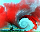 The air flow from the wing of this agricultural plane is made visible by a technique that uses colored smoke rising from the ground. The swirl at the wingtip traces the aircraft's wake vortex, which exerts a powerful influence on the flow field behind the plane.