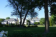 The estate and gardens of Wistariahurst, with the carriage house visible at the left