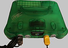A translucent green Nintendo 64 console with four controller ports in its front.