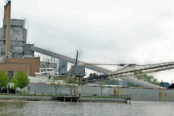 Gray freighter unloading at dockside