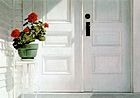 striking photo-realistic oil painting of white porch with double-doors, geranium plant on white stand