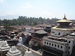 Streetscene with various characteristically shaped temple buildings.