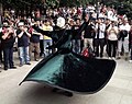 Protesters applaud a whirling Sufi wearing a gas mask.