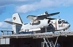 Colour photo of a military propeller aircraft with its wings folded