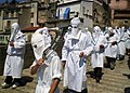 A confraternity of penitents in Italy mortifying the flesh with disciplines in a seven-hour procession; hoods similar to the capirote are worn by penitents in order to not draw attention to themselves, but to God (2010)