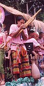 A Khene player wearing sarong and pakama at the Ubon Candle Festival