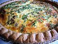 Una quiche a base di scalogni, cipolle, formaggio Emmental e porcini