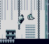 A monochromatic screenshot of Donkey Kong, a gorilla, hanging from a chain in a construction site. On his right, a banana bunch floats and another chain hangs.
