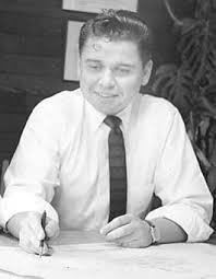 A black and white picture of Albert Bumgardner at his desk