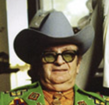 headshot of Nudie Cohn as an older man in a cowboy hat