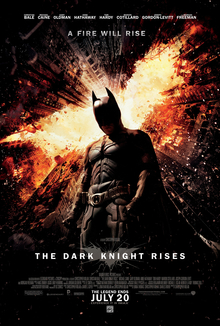 Batman stands beneath burning skyscrapers, which form a bat symbol above him. At the top of the image is a tagline, "A Fire Will Rise", along with the credits of the main cast. At the bottom of the image is the film's title, "The Dark Knight Rises", along with the billing block. Beneath these is the film's release date, the text reading "The Legend Ends July 20".