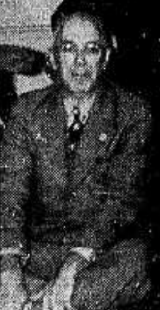 Black and white photo of Sterling in a suit and tie