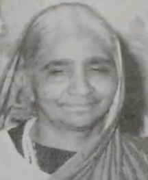 Older South Asian woman, smiling.