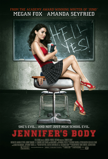 Jennifer holding books in her arms sitting on a school desk, wearing a red top and short plaid skirt, in front of a blackboard with the words HELL YES! written in chalk. A hand can be seen trapped by the lid of the school desk. The poster bears the tagline "She's evil ... and not just high school evil" in white block capitals, with the film title underneath in large red block capitals.
