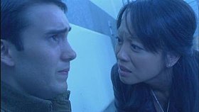 A man in a soldier's uniform looking anguished, and a British woman of Asian descent looking at him, concerned