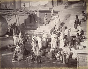 Women and children bathing and collecting water at a ghat in Banaras (Varanasi), the holy Hindu city on the banks of the Ganges river in northern India, 1885