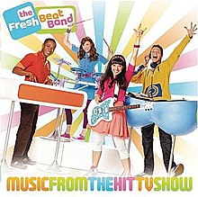 The Fresh Beats (from left: Shout, Marina, Kiki, Twist), pictured at an angle holding their respective instruments in front of a background of sun rays, colored pink, light blue, light green, yellow and orange, in that order, each separated by a white sunray