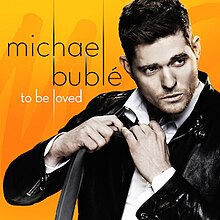 The cover features a man wearing a black leather jacket and white dress shirt, undoing a black tie. The artist's name and album title appear on the left side, colored in black and white respectively.