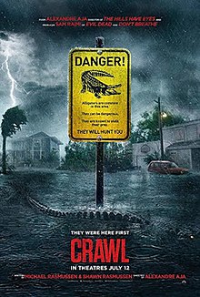 In the middle of a hurricane, an alligator swims past a bright yellow sign regarding gators reading "DANGER!" in a flooded street.